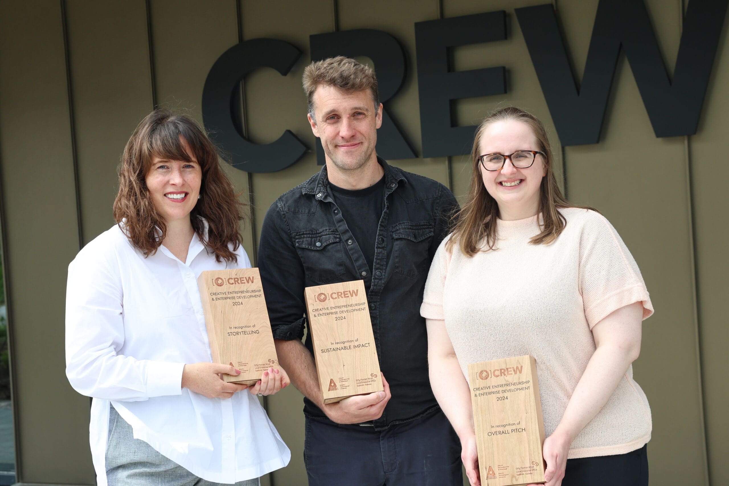 Three entrepreneurs with their awards in front of the CREW Enterprise Hub in Galway Ireland